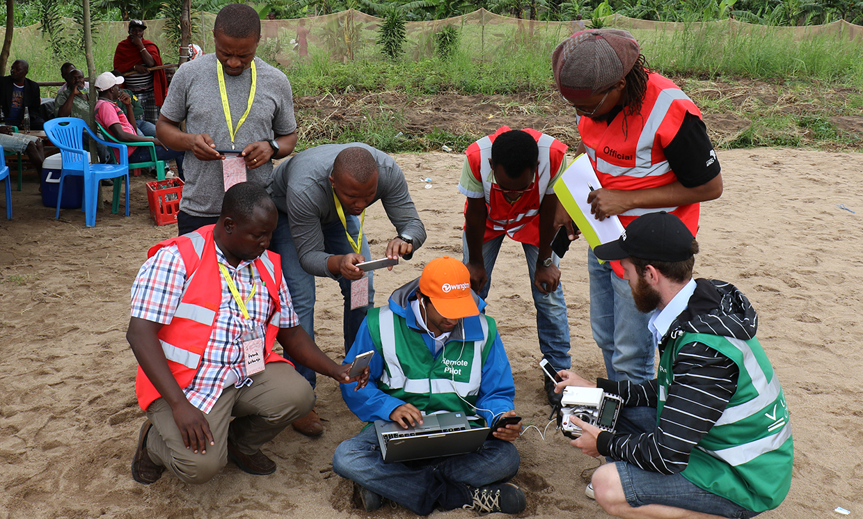 At the LVC launch area, safety-crew members and Juma community leaders gathered around two members of the Wingtra team who were monitoring their drone’s flight.