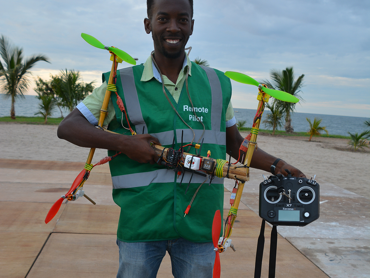Photo of Bornlove Ntikha holding his drone.