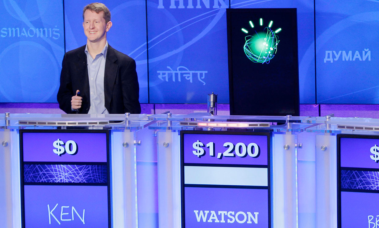 "Jeopardy!" champions Ken Jennings, left, looks on as "Watson" beats him to the buzzer.