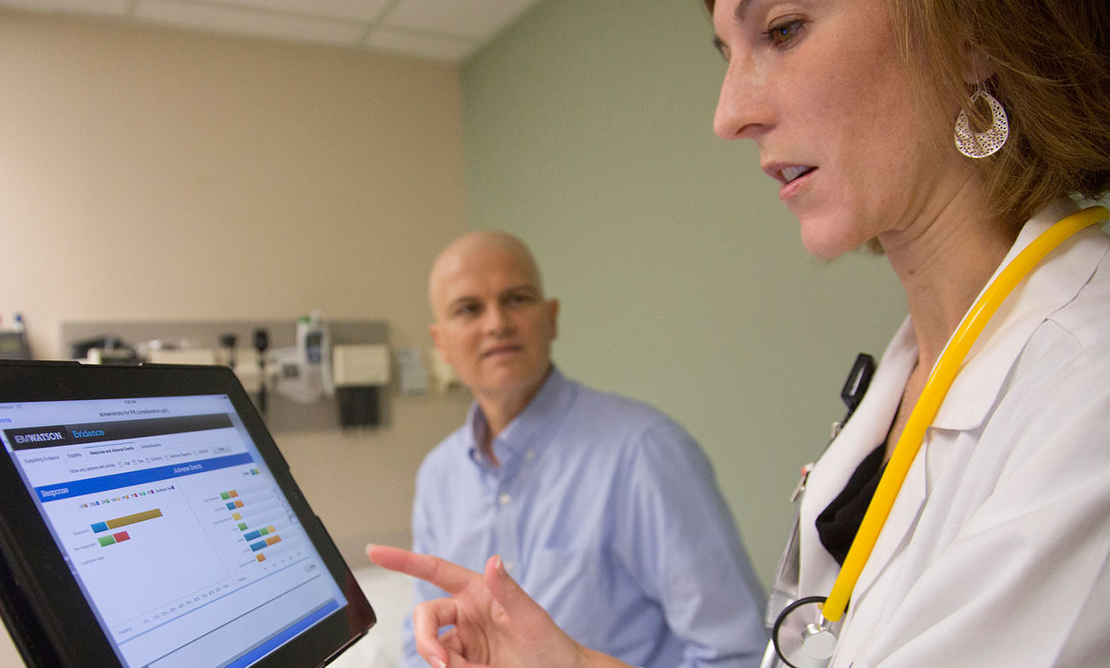 A University of Texas MD uses IBM's Watson cognitive system while consulting with patient.